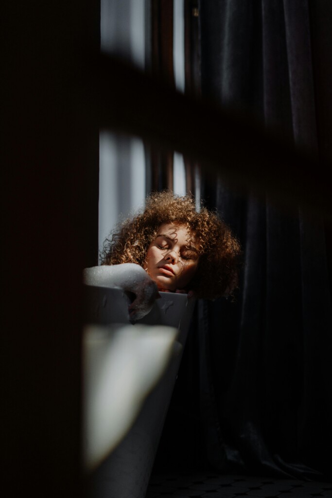 Woman resting her eyes in low light