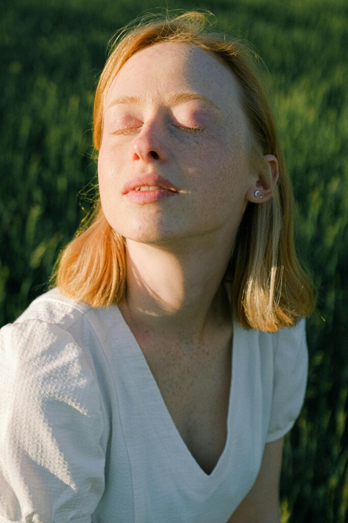 Woman standing outside in warm sunlight